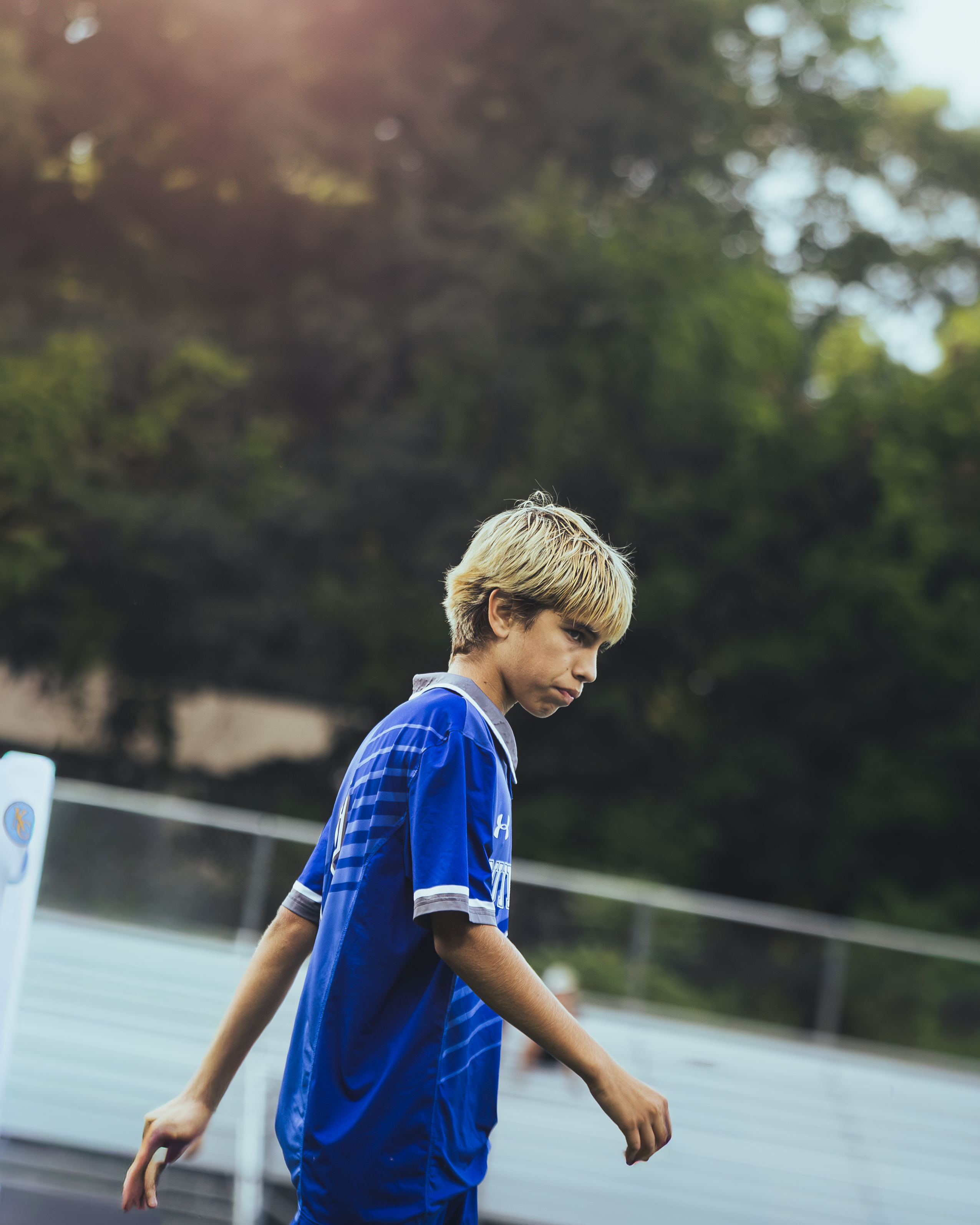 Soccer player walking along the touchline